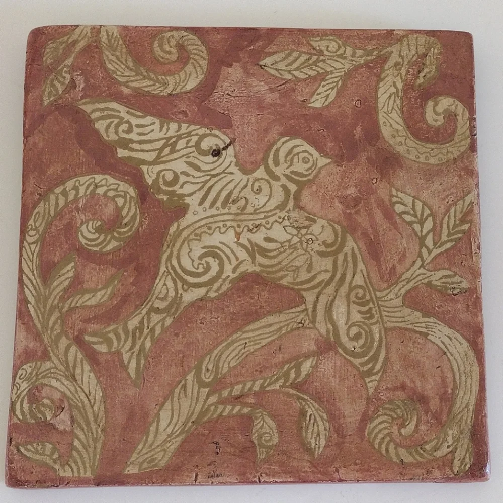 Kate McRostie hand-painted tile wall hanging with bird in bole